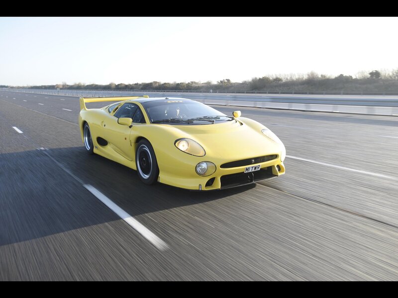yellow sports car on highway
