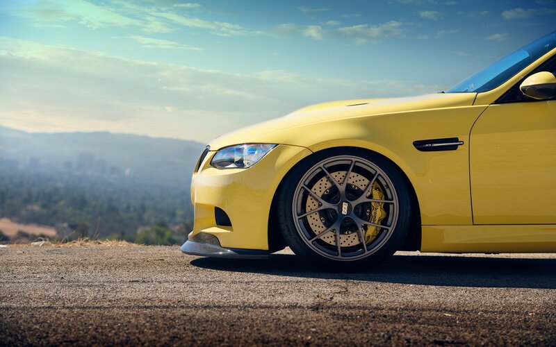 yellow sports car on hillside