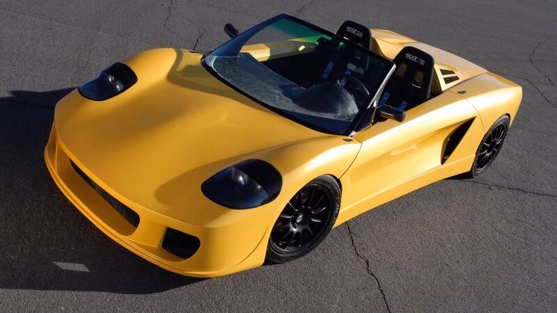 yellow sports car on pavement