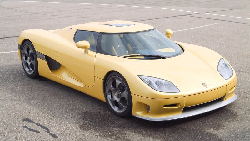 yellow sports car on pavement