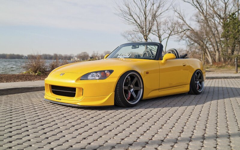 yellow sports car on pavement