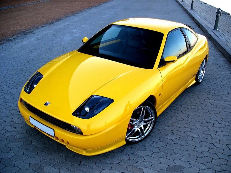 yellow sports car on pavement