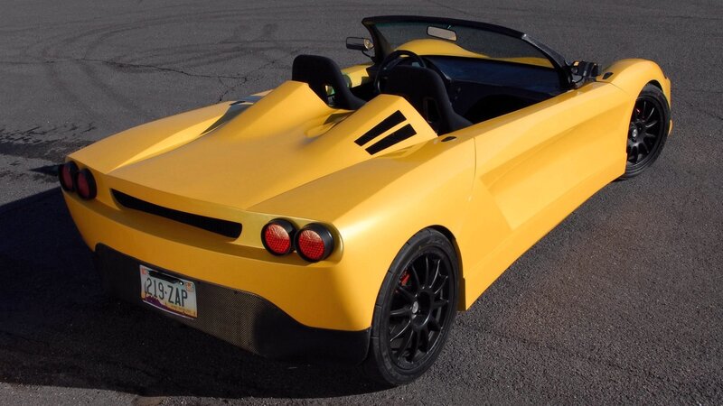 yellow sports car on pavement