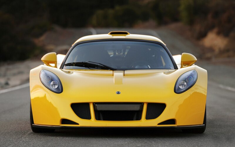 yellow sports car on road
