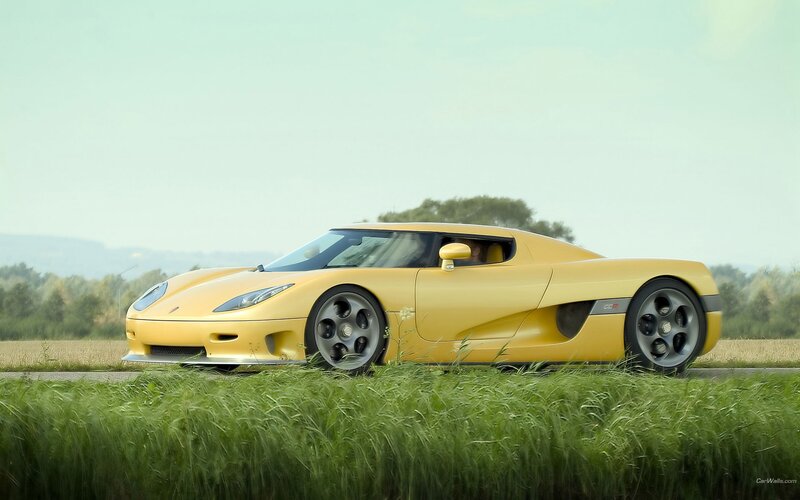 yellow sports car on road