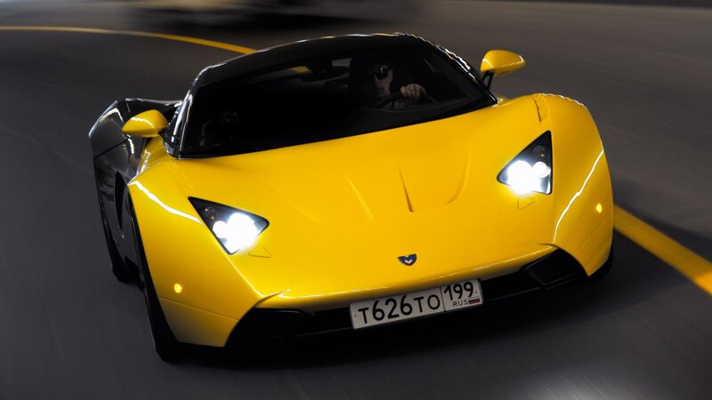 yellow sports car on road