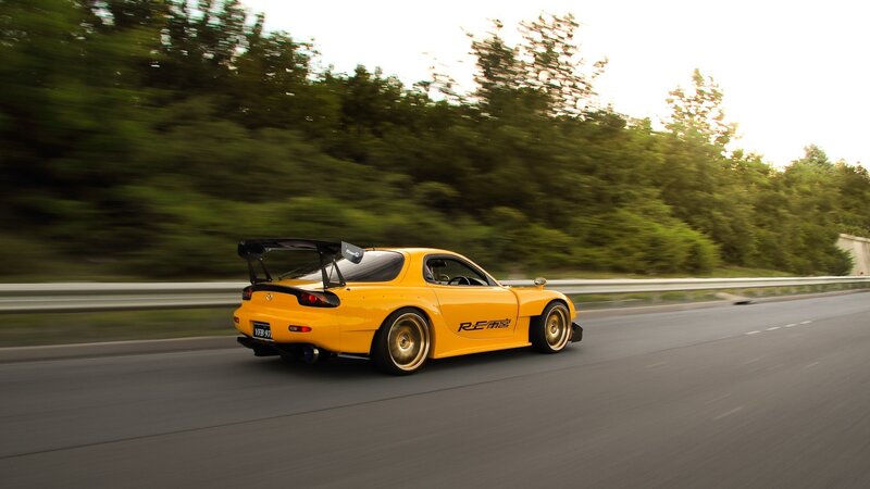 yellow sports car on road