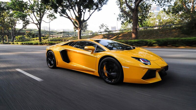 yellow sports car on road