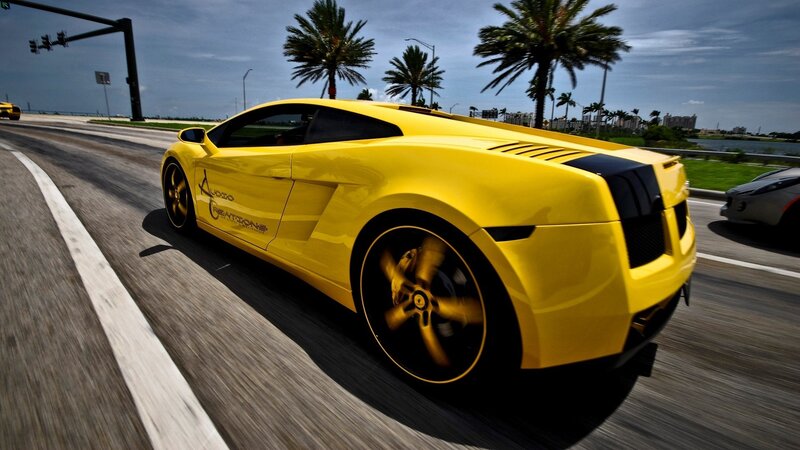 yellow sports car on road