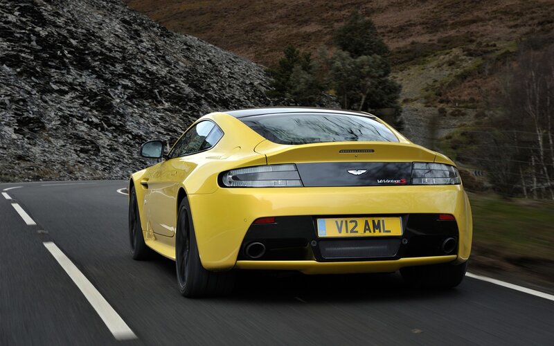 yellow sports car on road