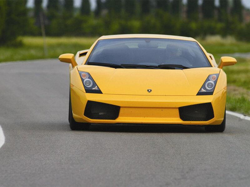 yellow sports car on road