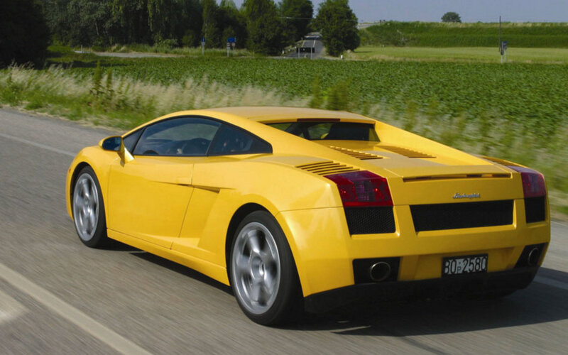 yellow sports car on road