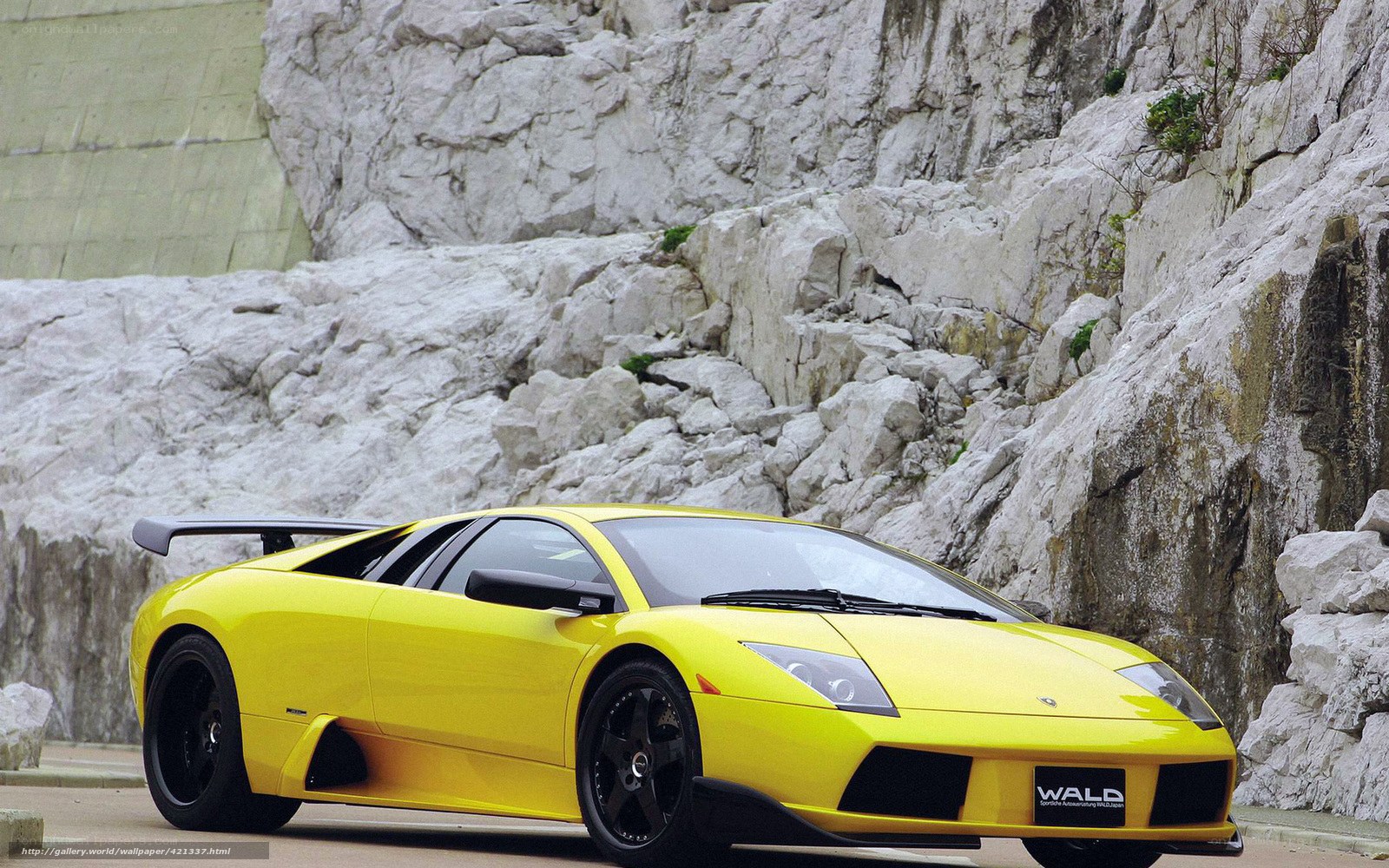 yellow sports car on rocky road