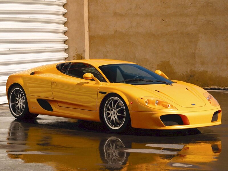 yellow sports car on wet pavement