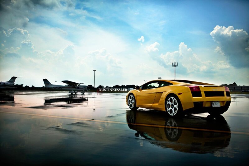 Yellow sports car on wet tarmac