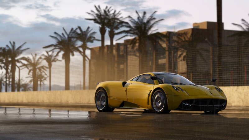 yellow sports car on wet track