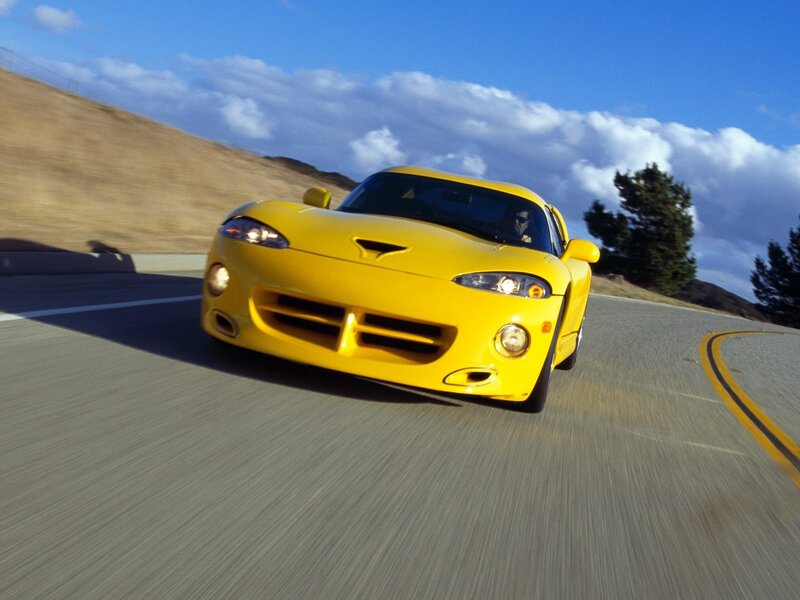 yellow sports car on winding road