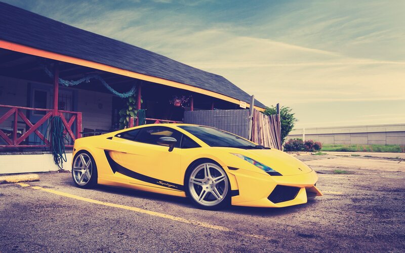 yellow sports car parked outside