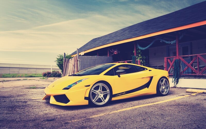 yellow sports car parked outside