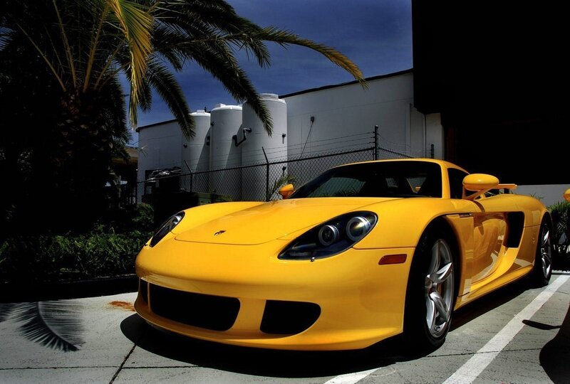 Yellow sports car parked outside