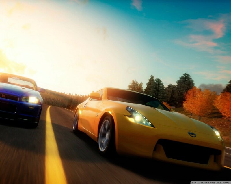 Yellow sports car racing at sunset