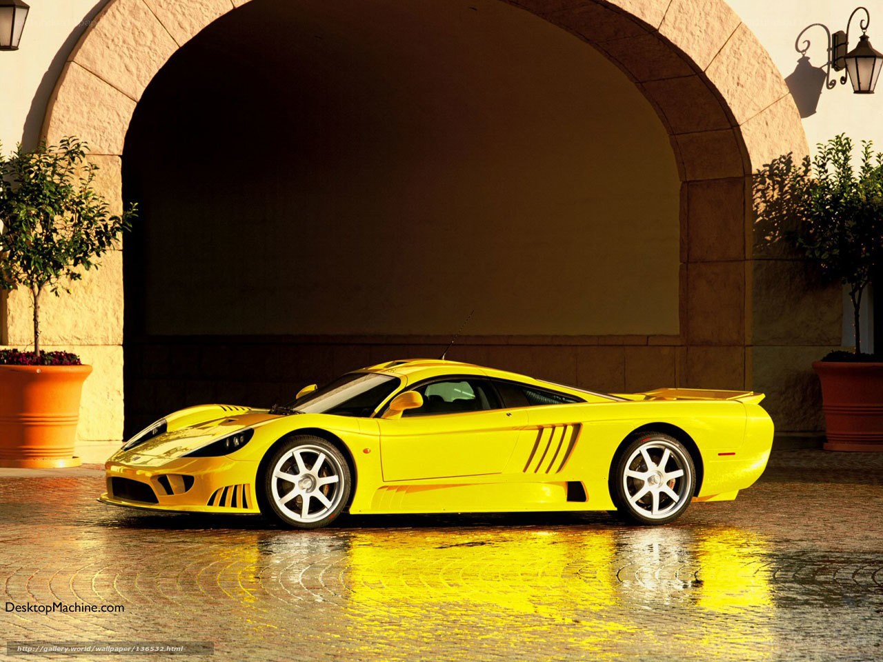 yellow sports car under arch
