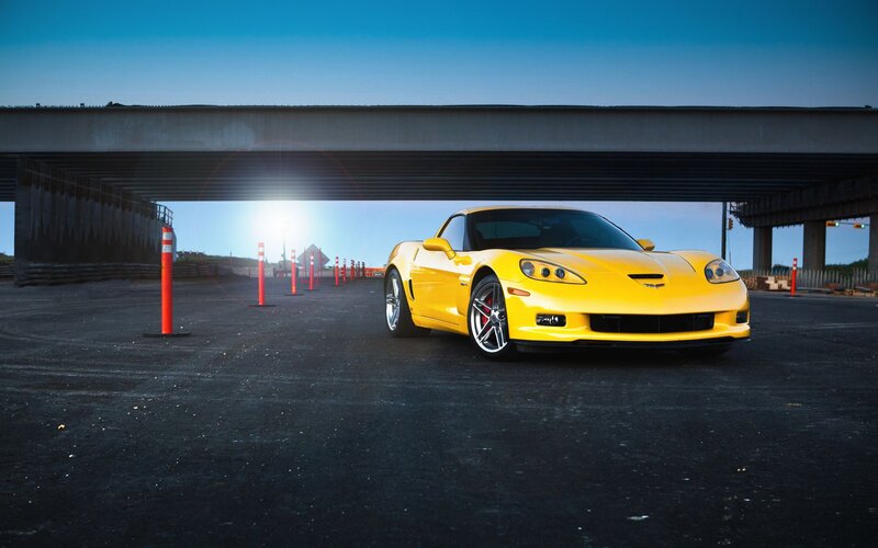 Yellow sports car under overpass