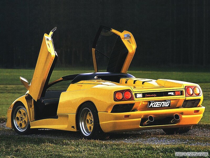 yellow sports car with doors open