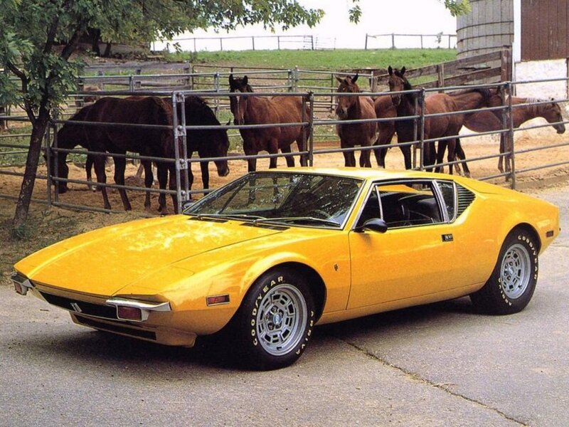 Yellow sports car with horses