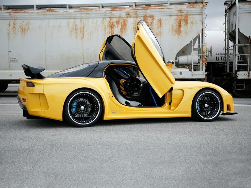 yellow sports car with open doors