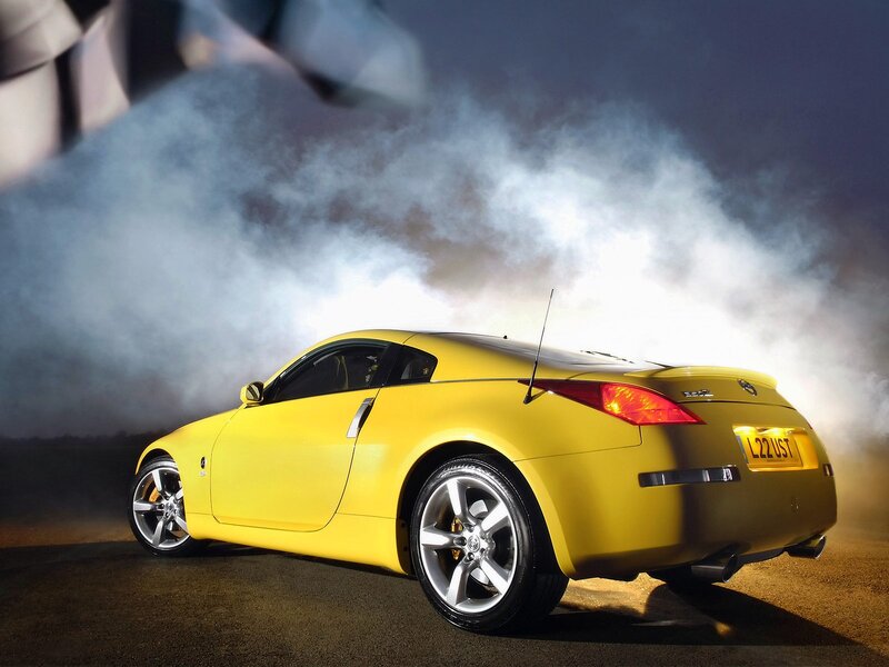 Yellow sports car with smoke