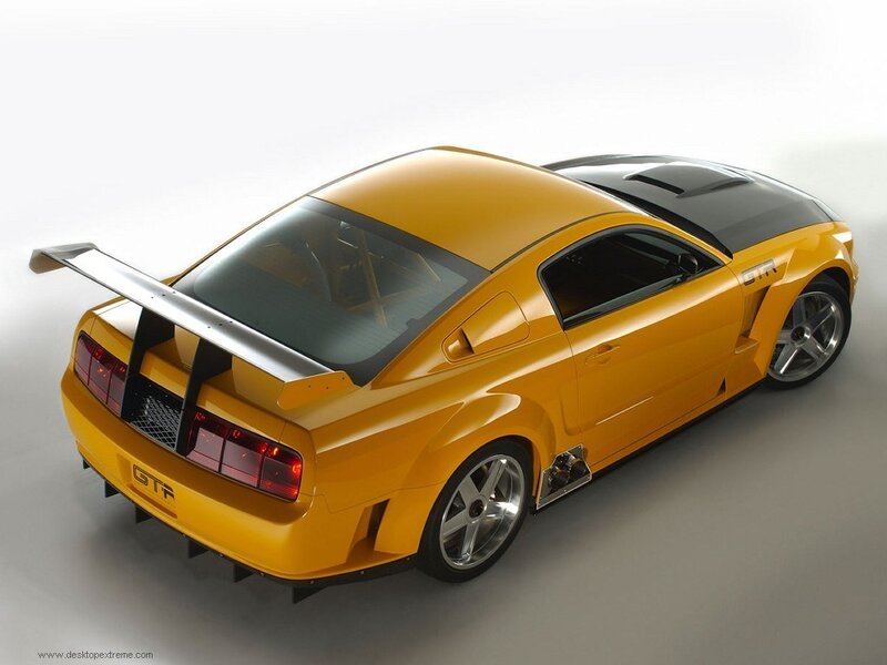yellow sports car with spoiler