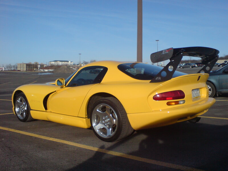 yellow sports car with spoiler
