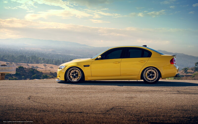 yellow sports sedan on hilltop