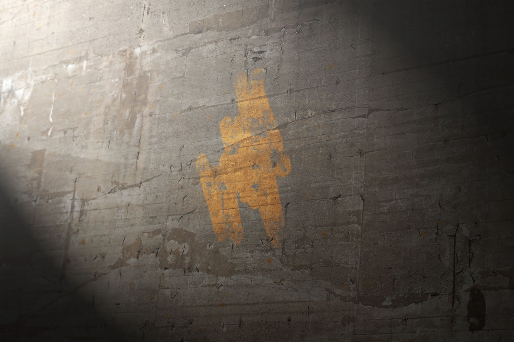 yellow stencil on concrete wall