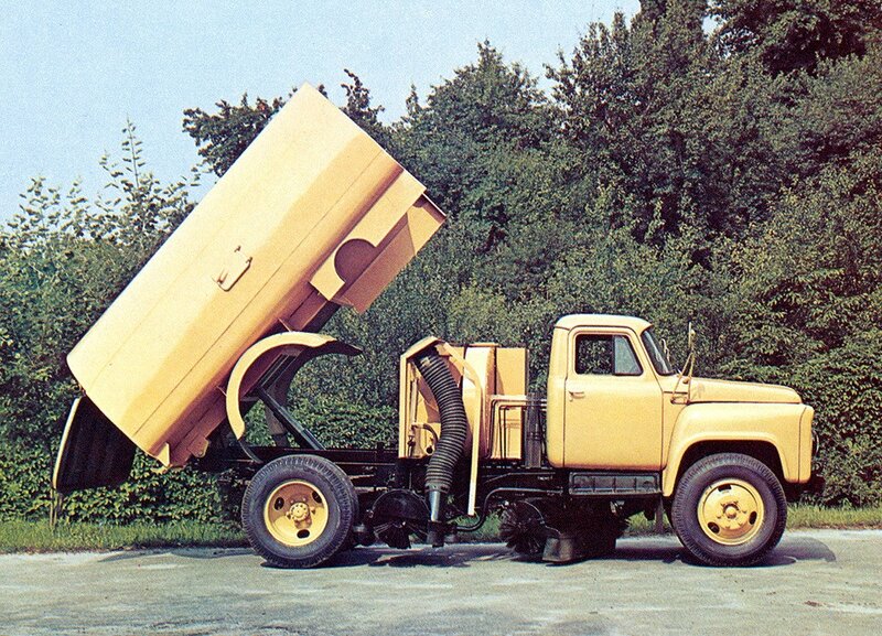 Yellow street sweeper truck