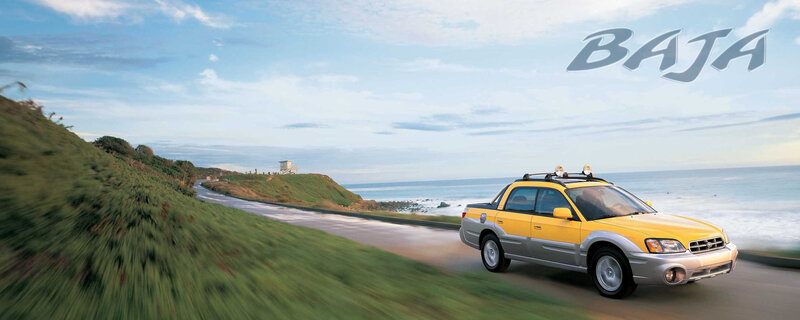 Yellow Subaru Baja on coastal road