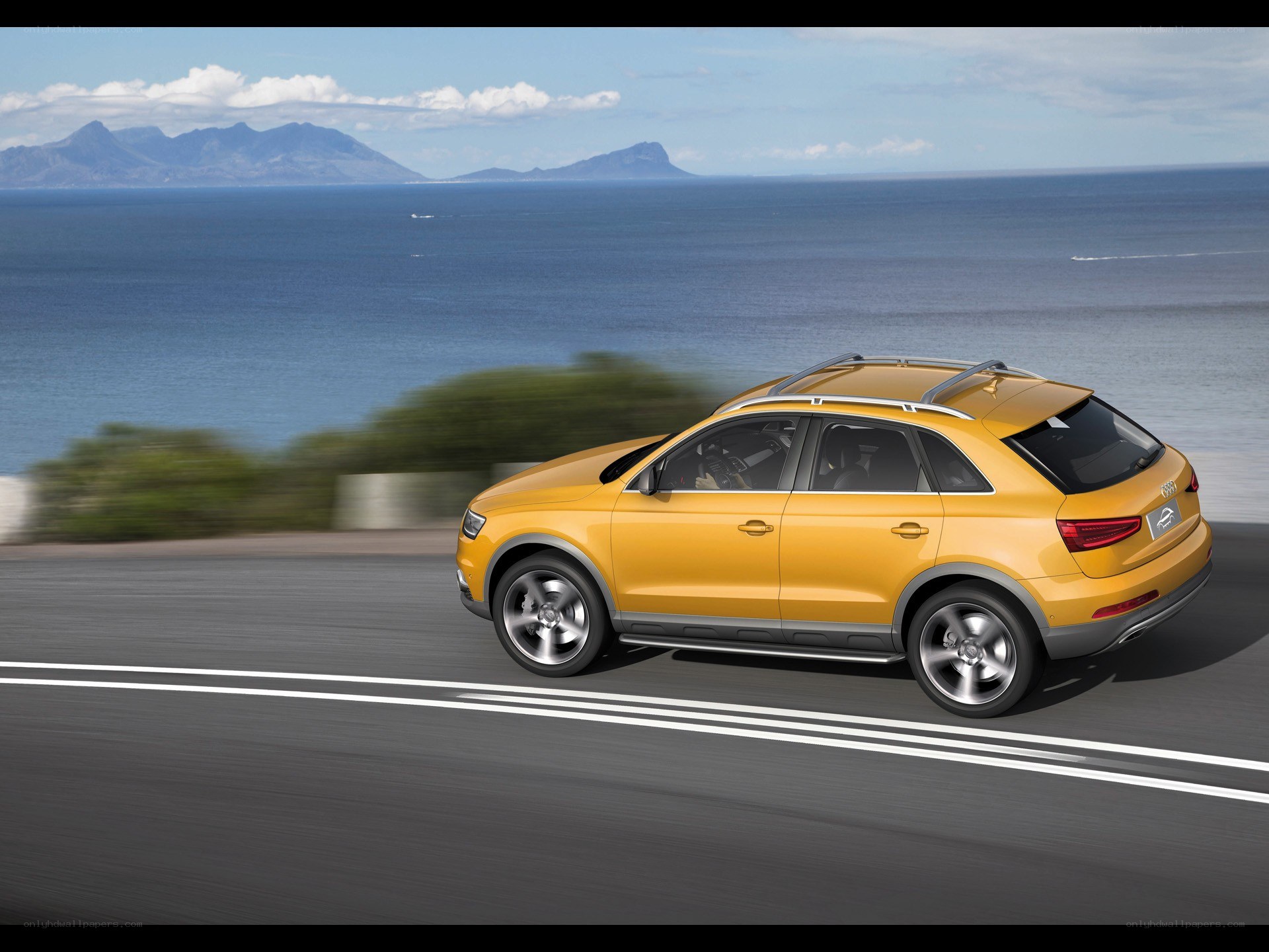 Yellow SUV on coastal road