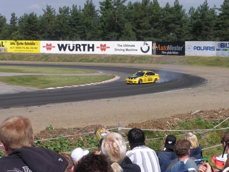 Yellow taxi car drifting on track