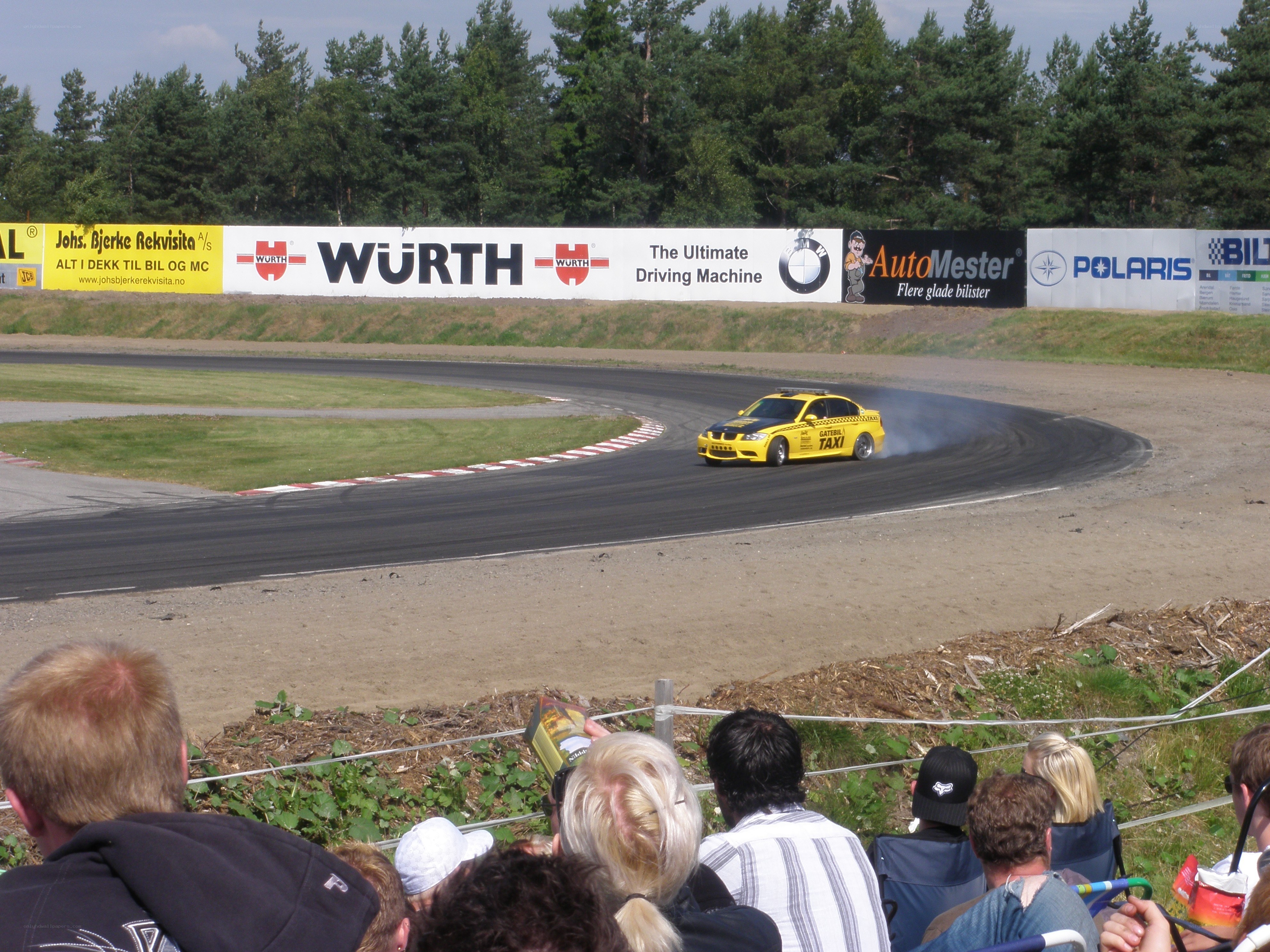 Yellow taxi car drifting on track