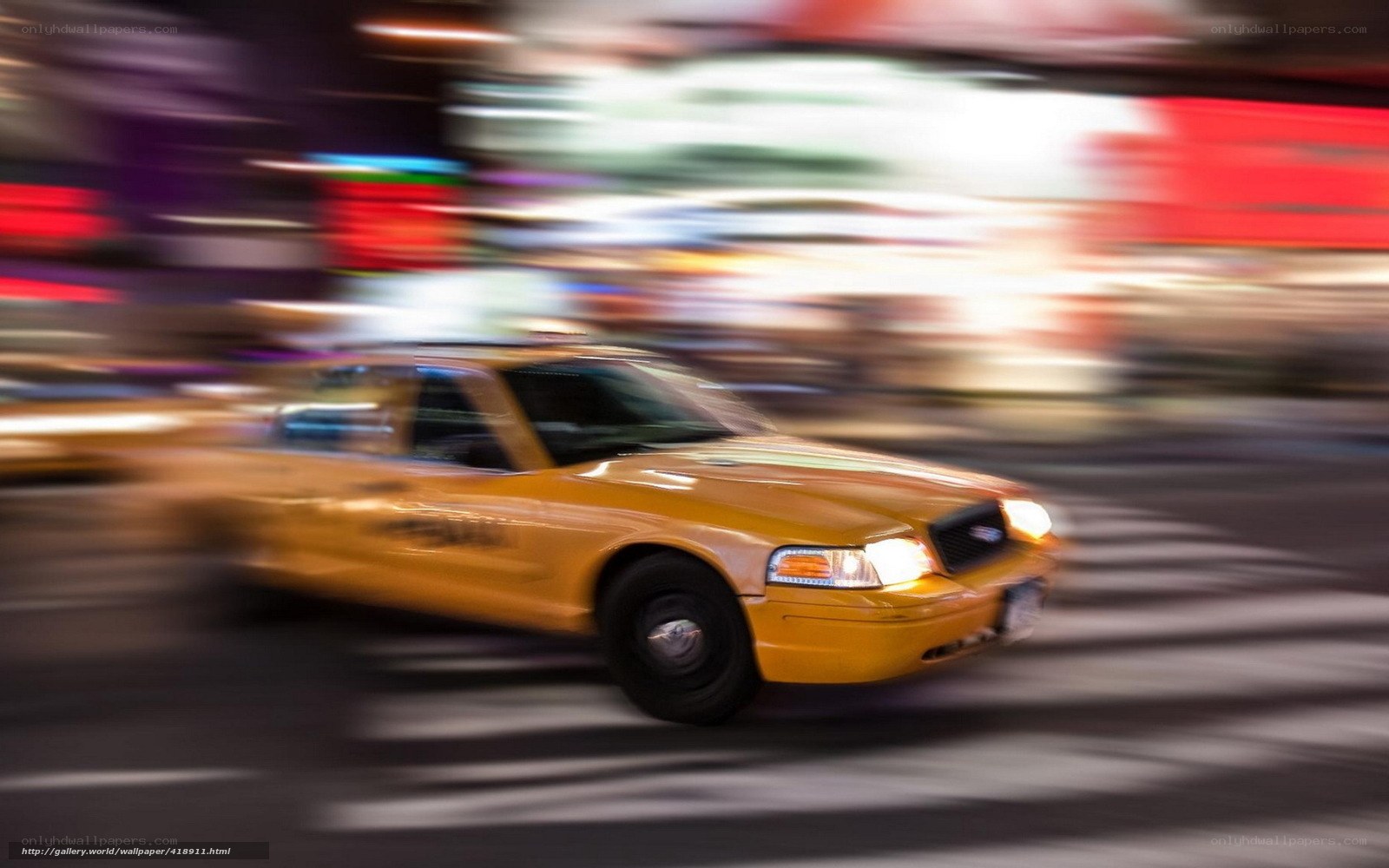 Yellow taxi in motion at night