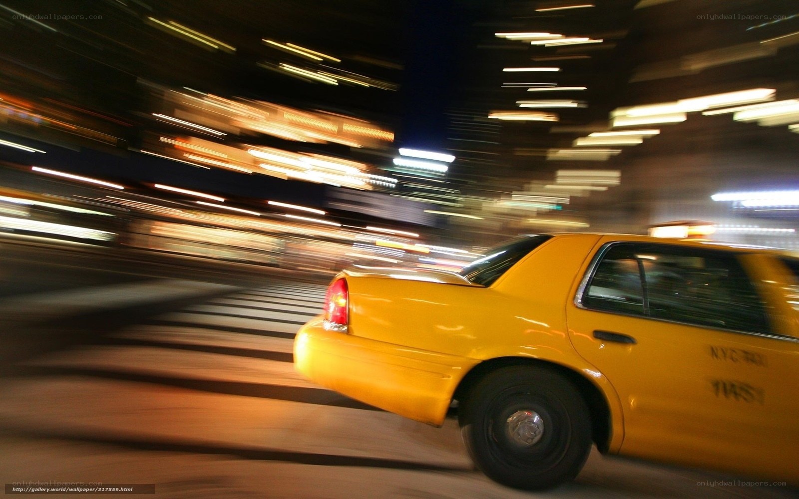 Yellow taxi in motion at night