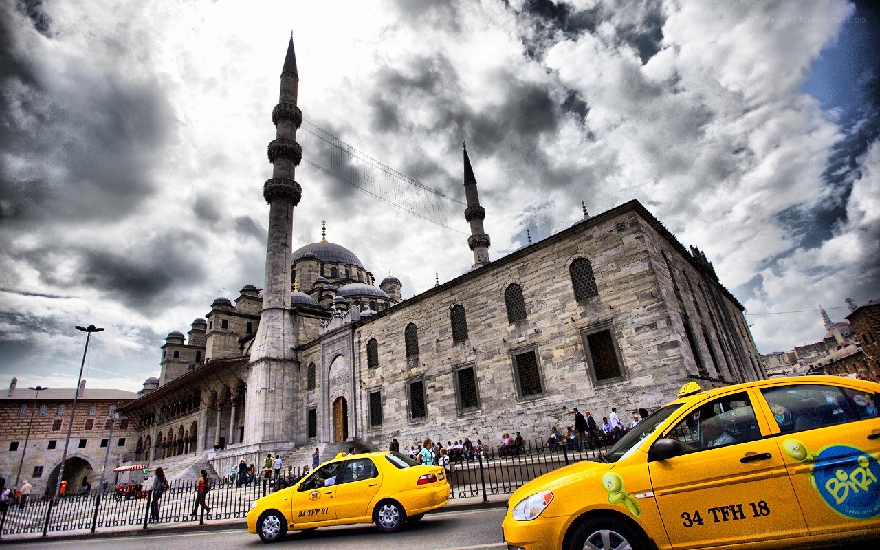 Yellow taxis near a mosque