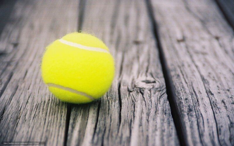 yellow tennis ball on wood