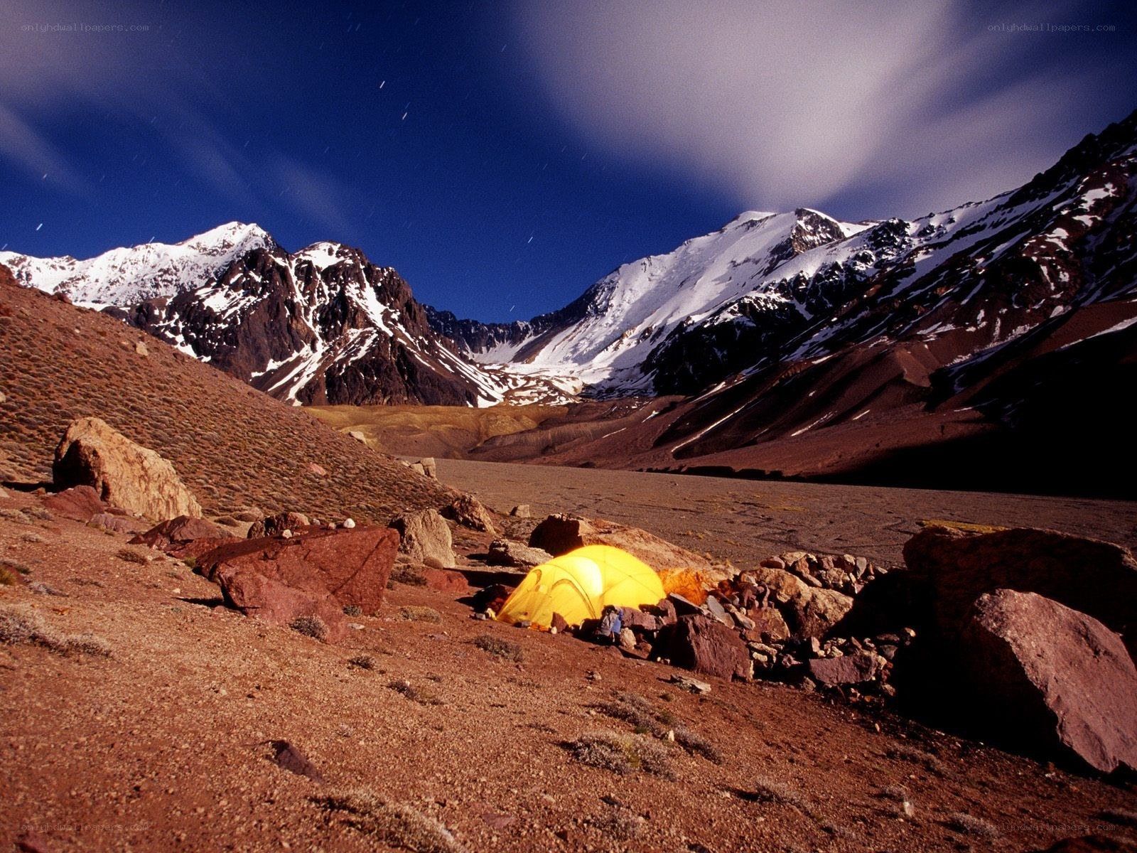 Yellow tent in mountain valley