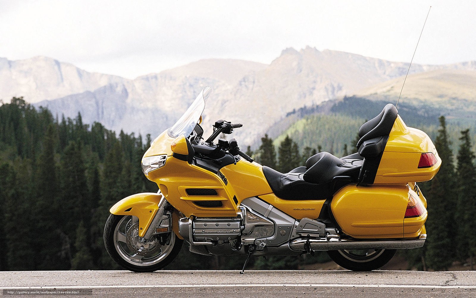 Yellow touring motorcycle on mountain road