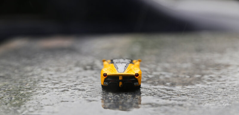 Yellow Toy Car — Dramatic, Photograph, Wet Surface