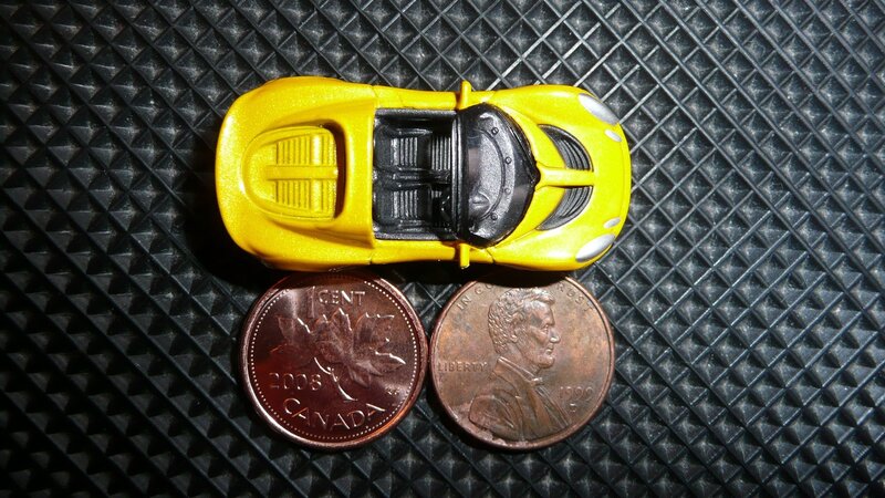 Yellow Toy Car — Neutral, Photograph, Coin
