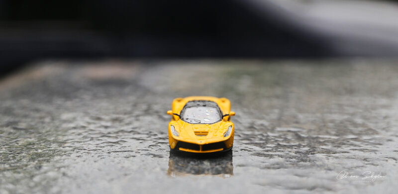 Yellow Toy Car on Wet Surface