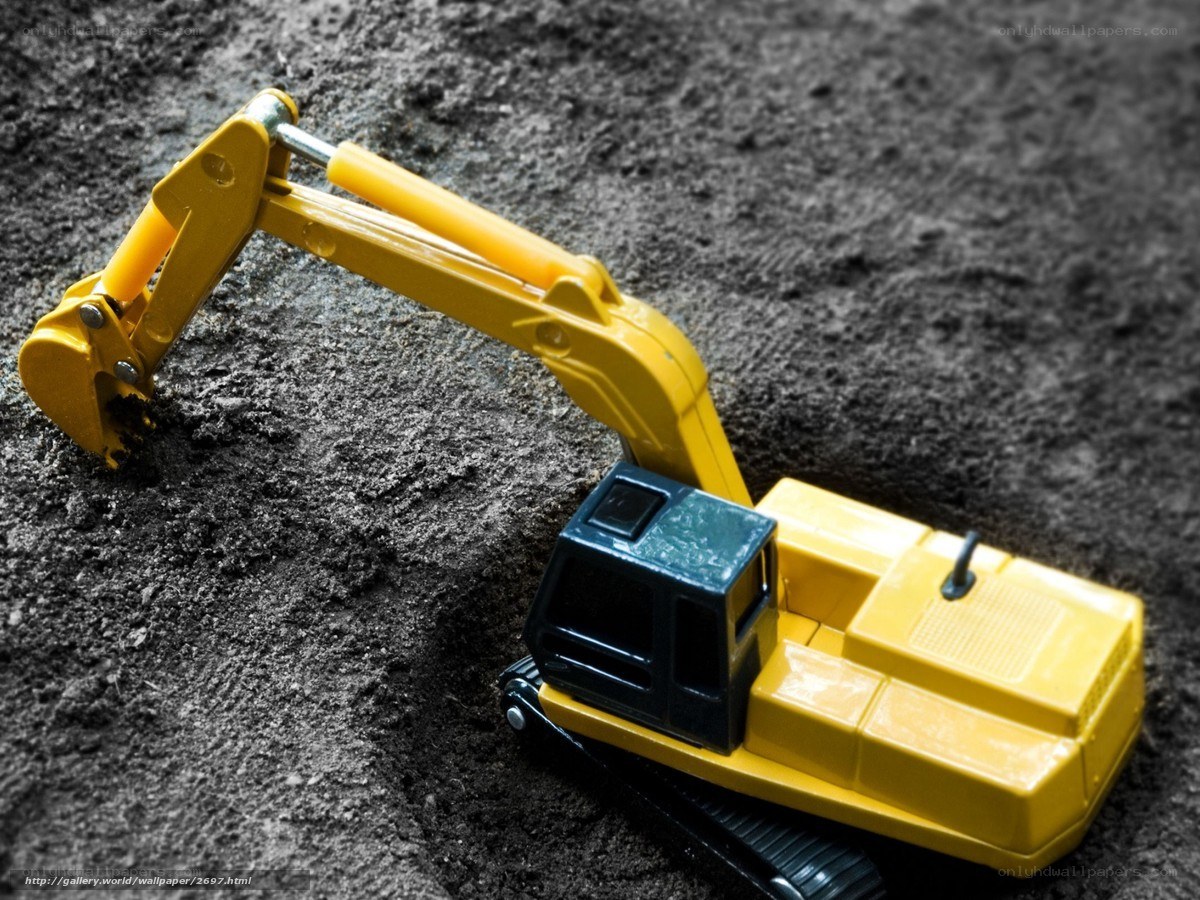 yellow toy excavator on dirt